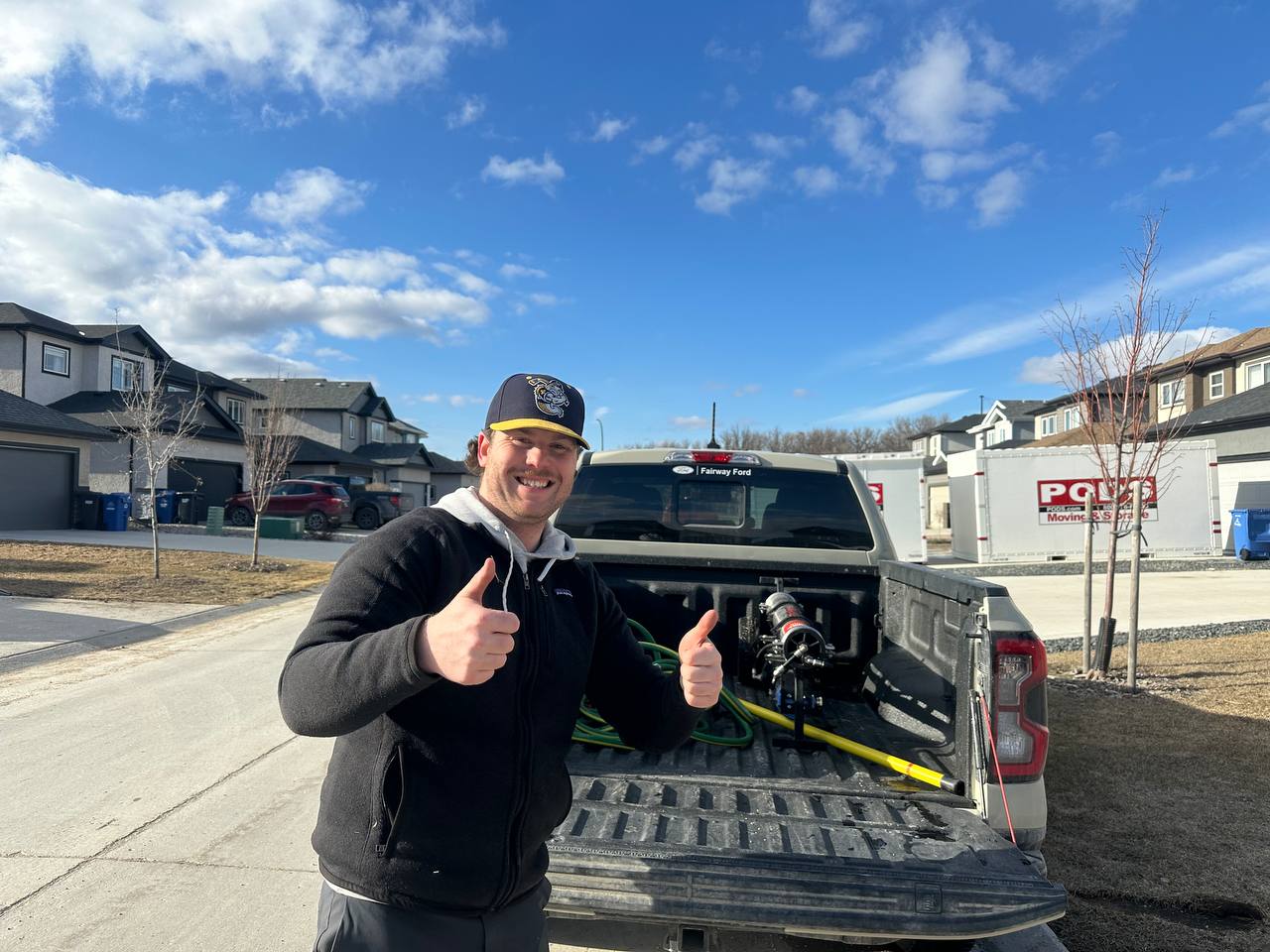 Kirk beside the Window Guys pickup truck and cleaning equipment